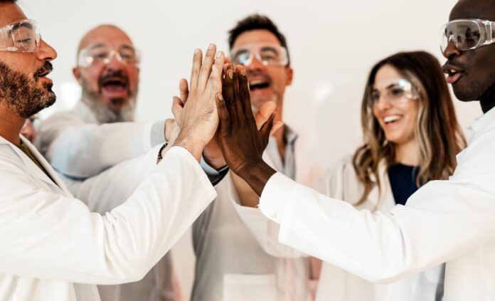 doctors high-fiving each other